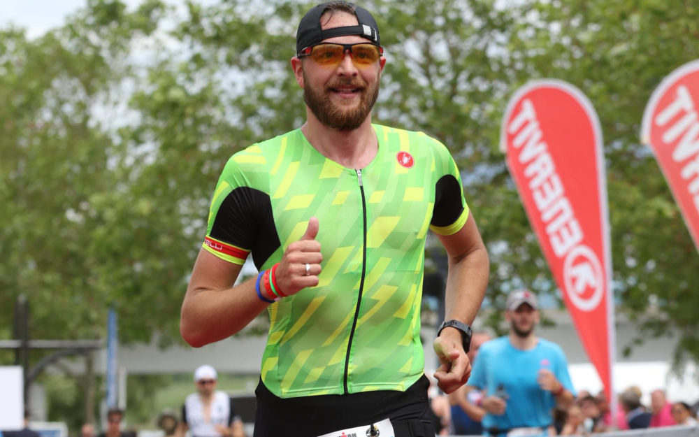 Philipp im Zielbereich eines Triathlons, Daumen nach oben